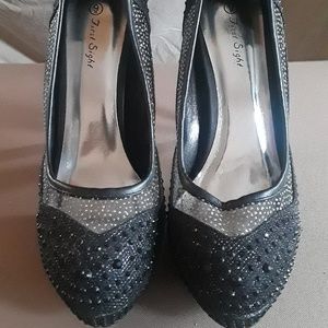 Elegant pumps with rhinestones and mesh detailing.